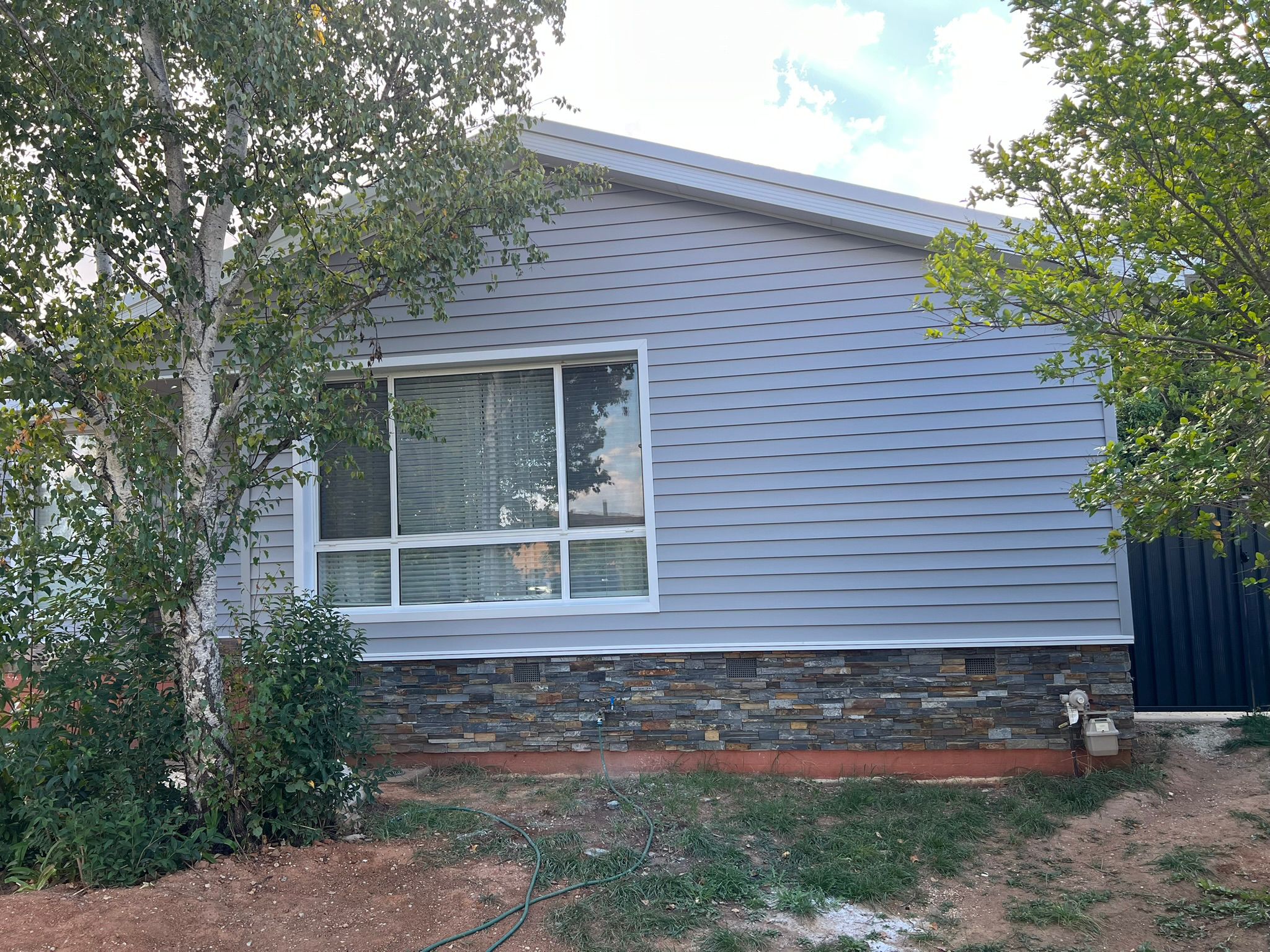 Dominion cladding facade with Blackbutt timber deck, Flynn Canberra